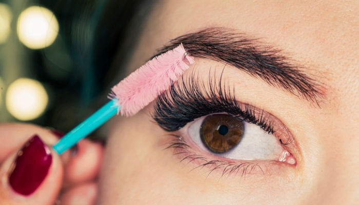 What are some of the most common mistakes people make when brushing their eyelash extensions?